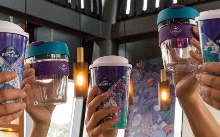 Reusable Java Republic cups being held in the air