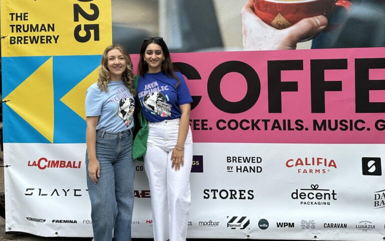 Laura McKitterick and Anushka Bedi standing in front of the London Coffee Festival 2025 sign