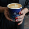 Hands holding coffee in a Java Republic cup