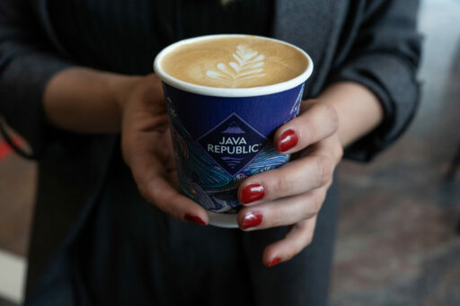 Hands holding coffee in a Java Republic cup