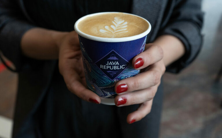 Hands holding coffee in a Java Republic cup