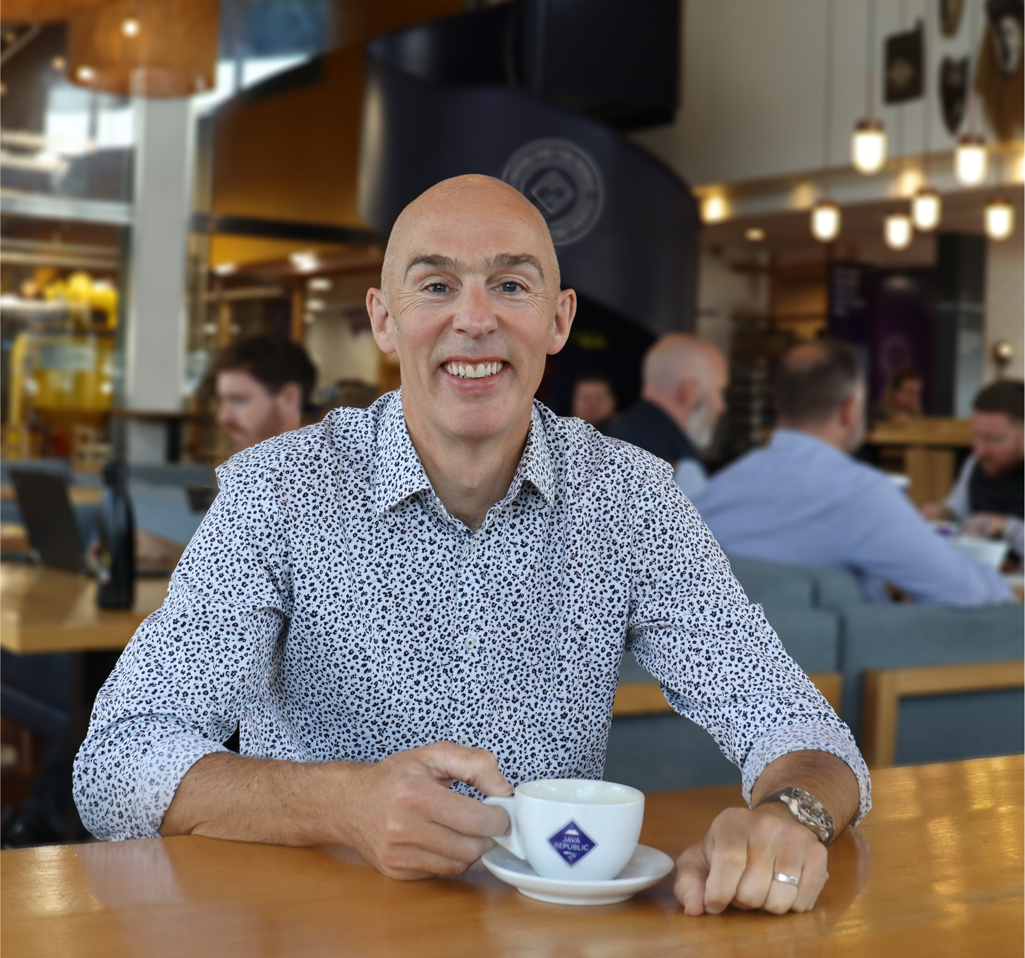 Jeffrey Long, Managing Director at Java Republic sits in a café holding a cup of coffee